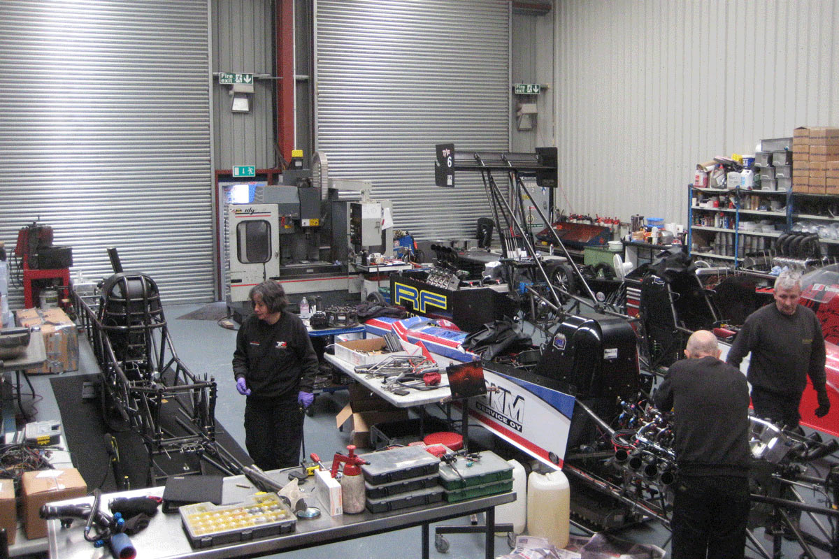 team getting cars ready in workshop